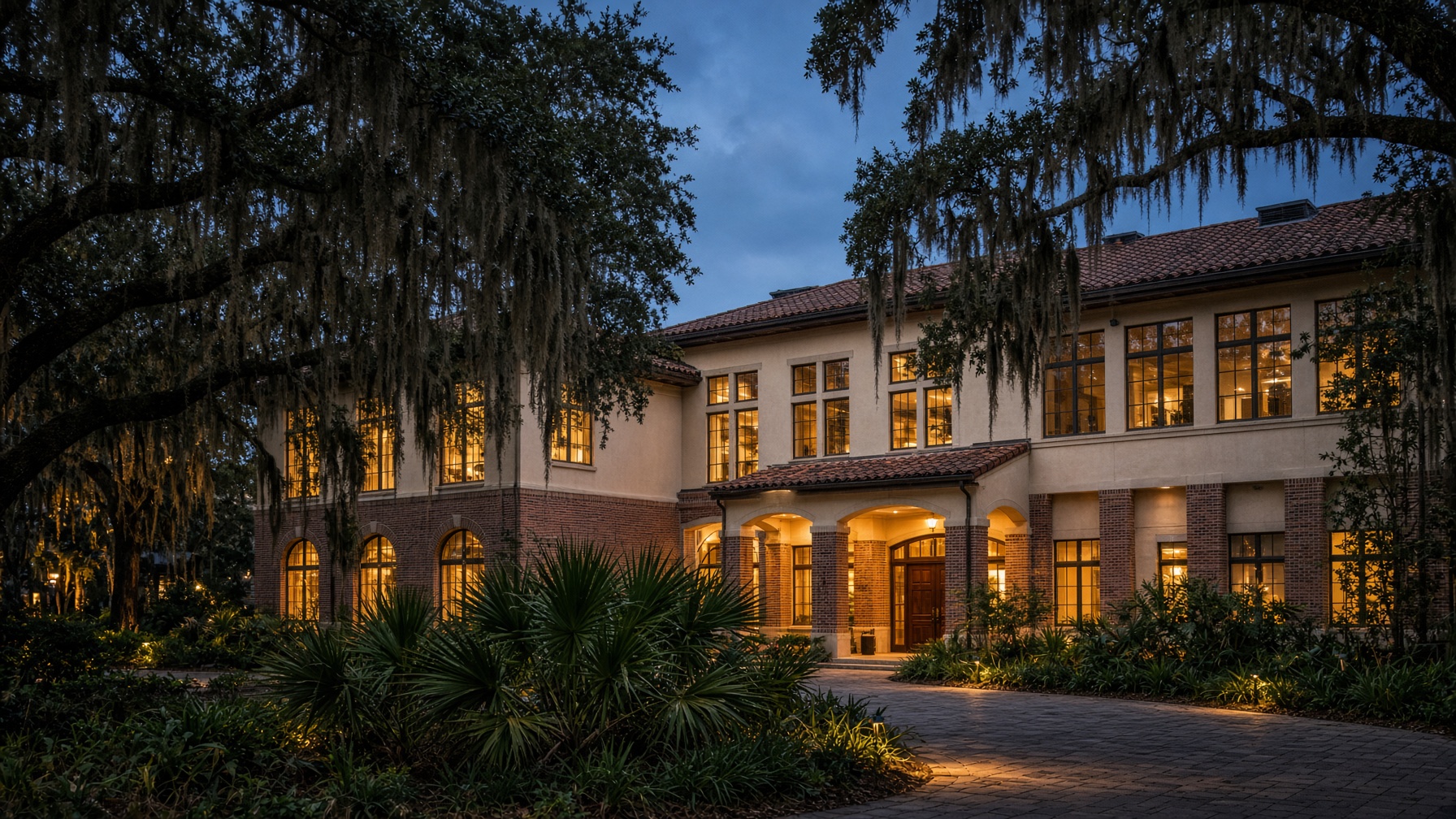 Winter Park, Florida medical campus at dusk with live oaks and a clay-tile medical pavilion